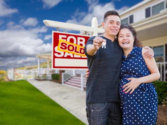 Hispanic Couple with Keys In Front of Home and Sign  Small